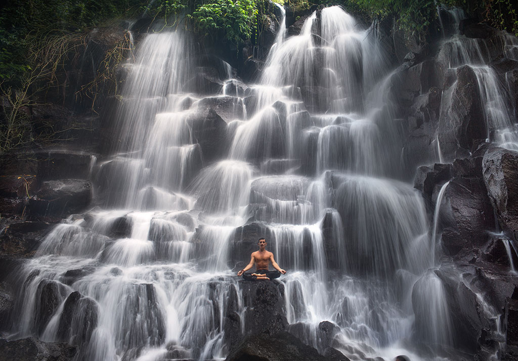 Flow meditation at the Kanto Lampo waterfall in Bali.